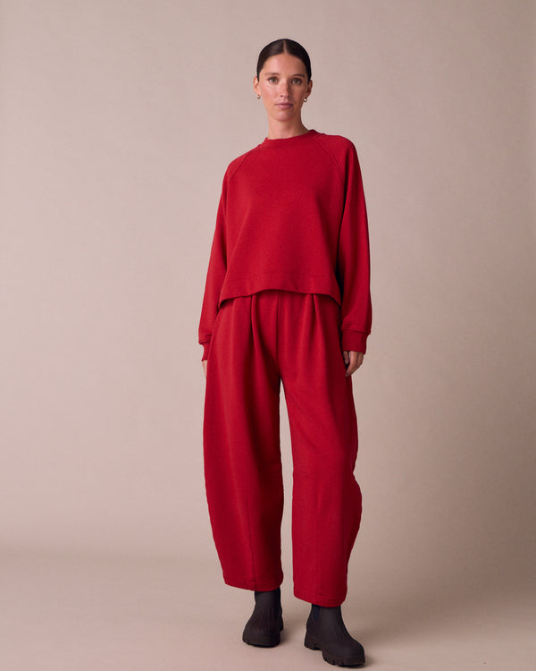 model wears daisy cherry red fleeceback jersey trousers right