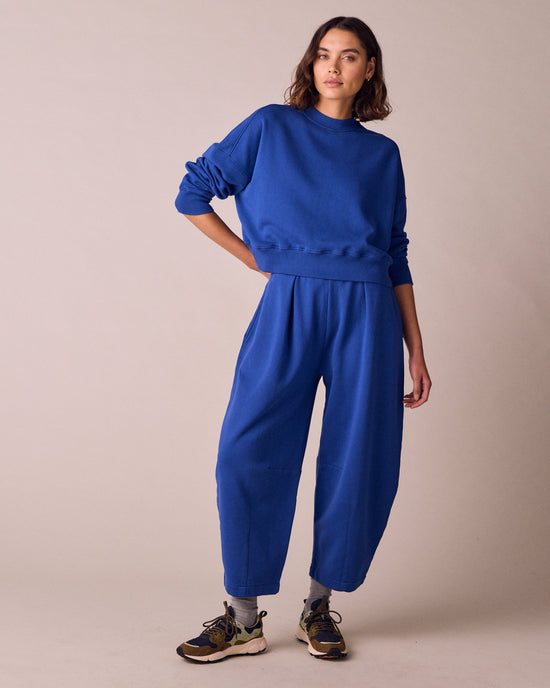 model wears daisy cobalt jersey fleeceback trousers right