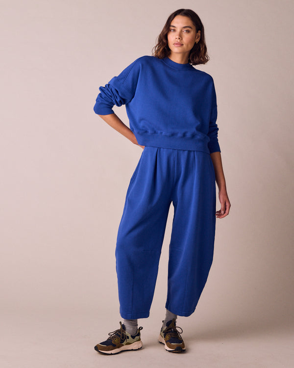 model wears daisy cobalt jersey fleeceback trousers right