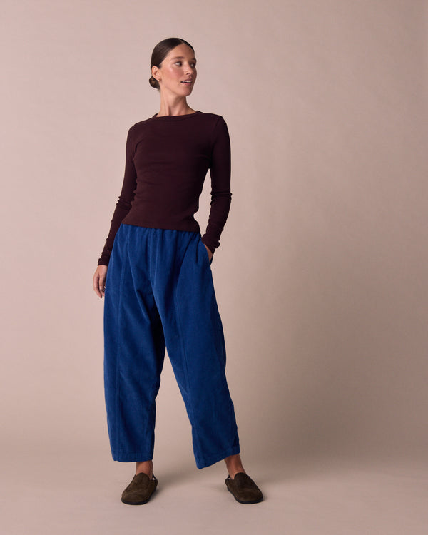 model wears mabel lapis blue cord trousers left