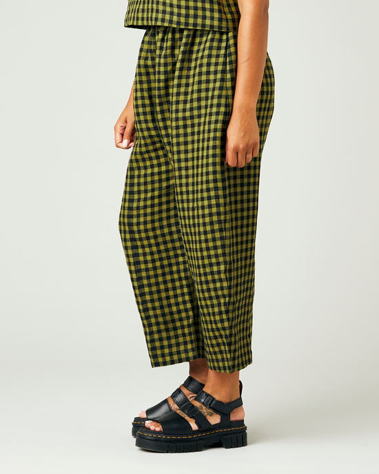 model wears green gingham linen mabel trousers from the left