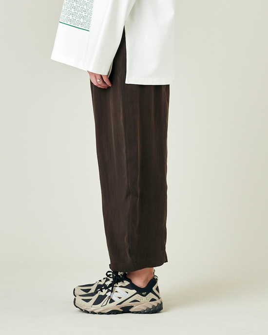 model wears espresso cupro mabel trousers left