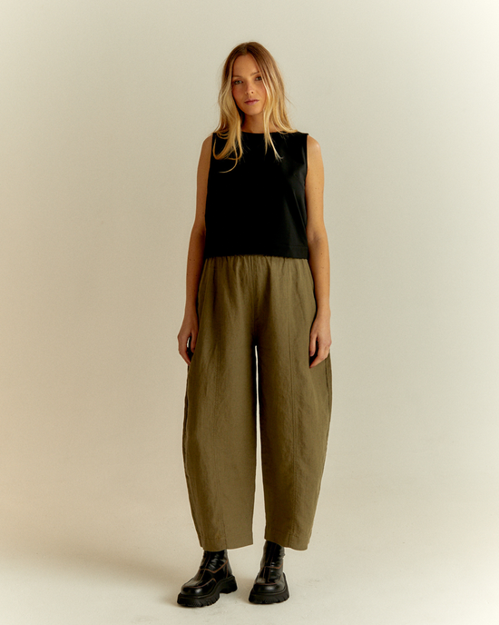 pregnant model wears khaki linen mabel trousers