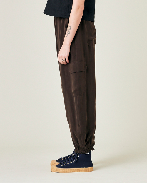 model wears espresso cupro sylvie trousers left