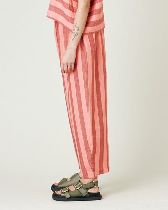 model wears blush stripe mabel trousers from the left