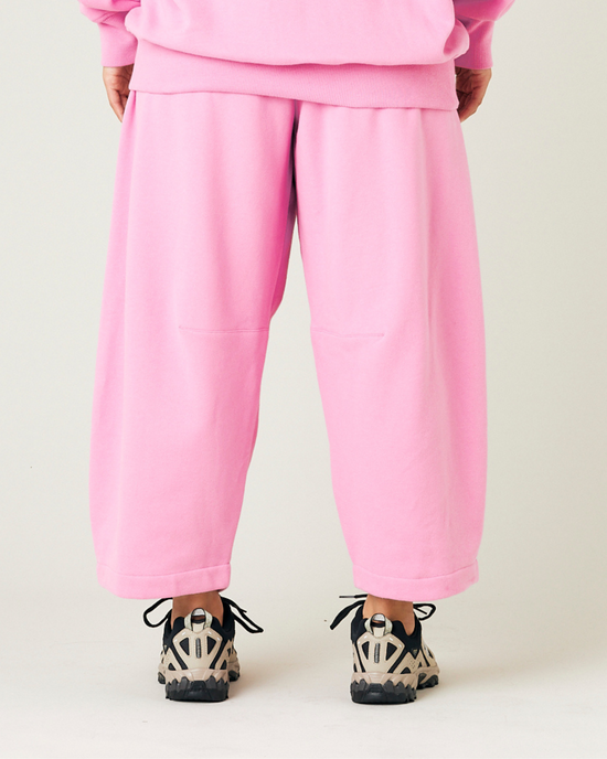 model wears pink daisy jersey trousers back