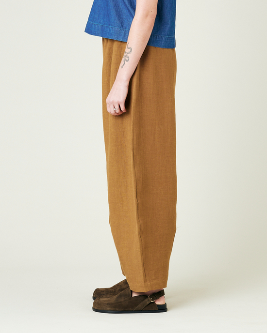 model wears bronze daisy linen trousers left