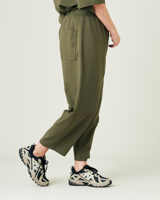 model wears olive huxley jersey trousers right