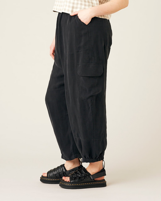 model wears black cupro sylvie trousers left