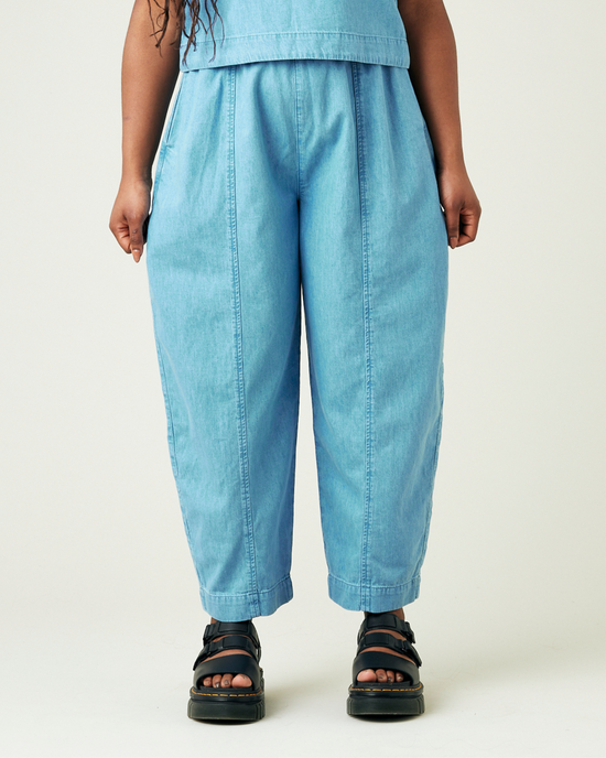 model wears light wash chambray mabel trousers front