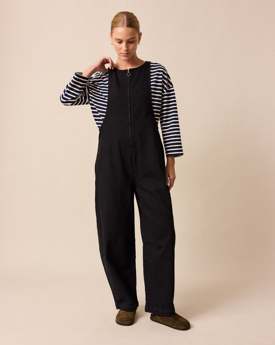 model wears ada black denim jumpsuit