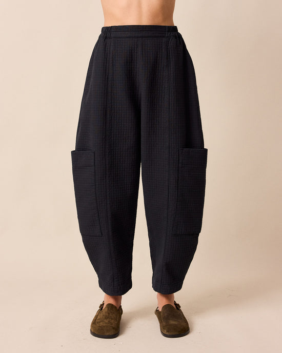 model wears amala black quilted cotton trousers front