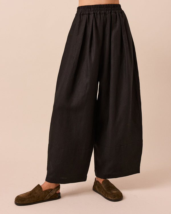 model wears black bobbi linen trousers front