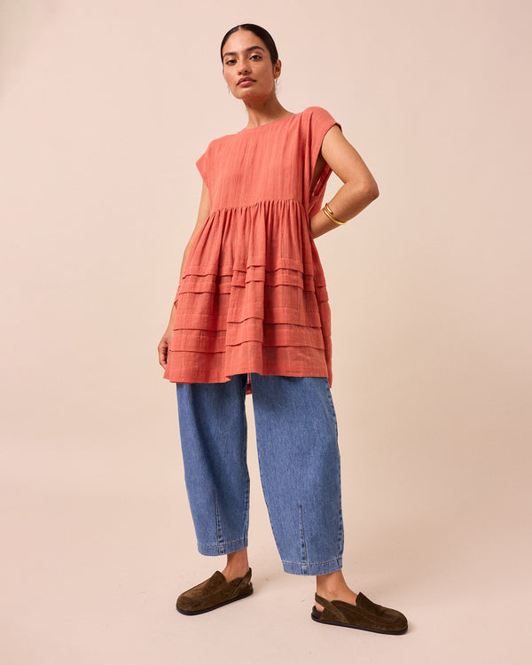 model wears ella terracotta cotton gauze dress
