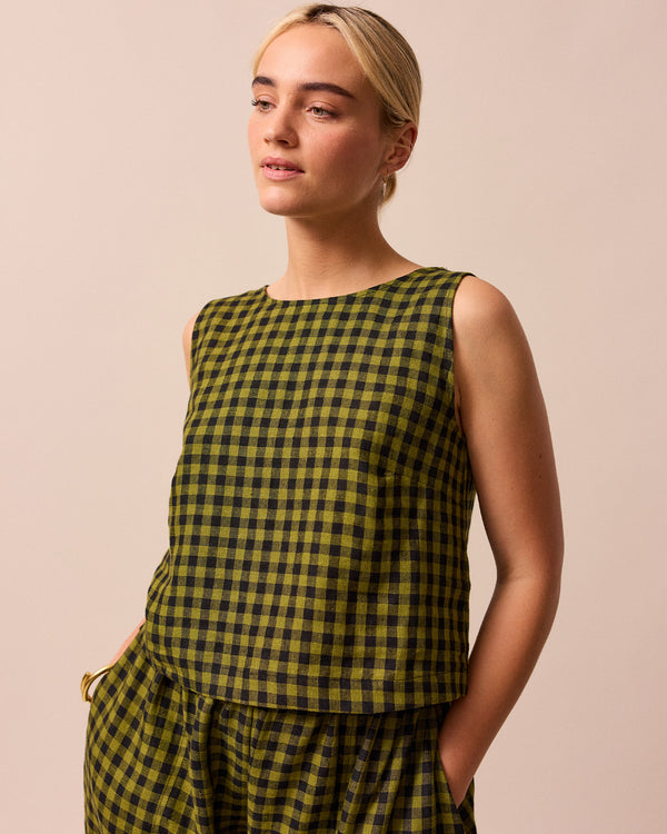 model wears green gingham linen esme top