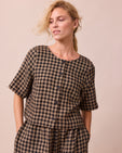 model wears evelyn coffee gingham linen top front
