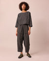 model wears huxley black mini grid linen trousers right