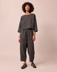 model wears huxley black mini grid linen trousers right