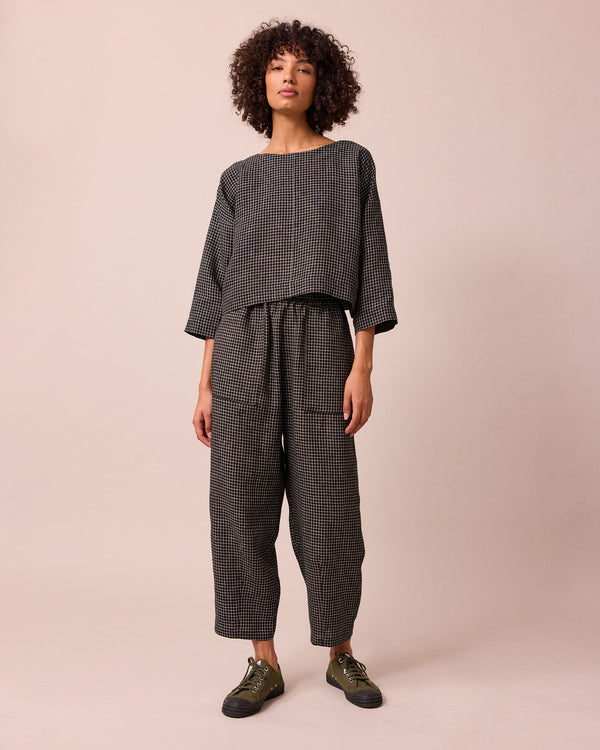 model wears huxley black mini grid linen trousers right