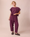 model wears huxley mulberry plaid linen trousers right