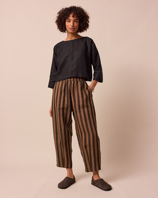 model wears walnut stripe huxley linen trousers front