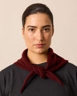 model wears dark burgundy knitted neckerchief