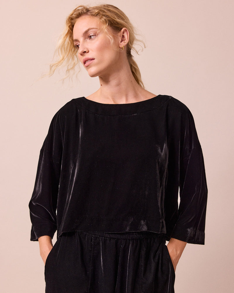 model wears lily black velvet top