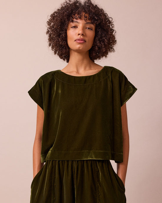 model wears polly moss green velvet top