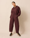 model wears lyra burgundy fleeceback jersey trousers left