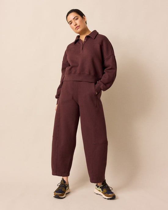 model wears lyra burgundy fleeceback jersey trousers left