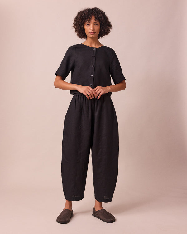 model wears mabel black linen trousers right
