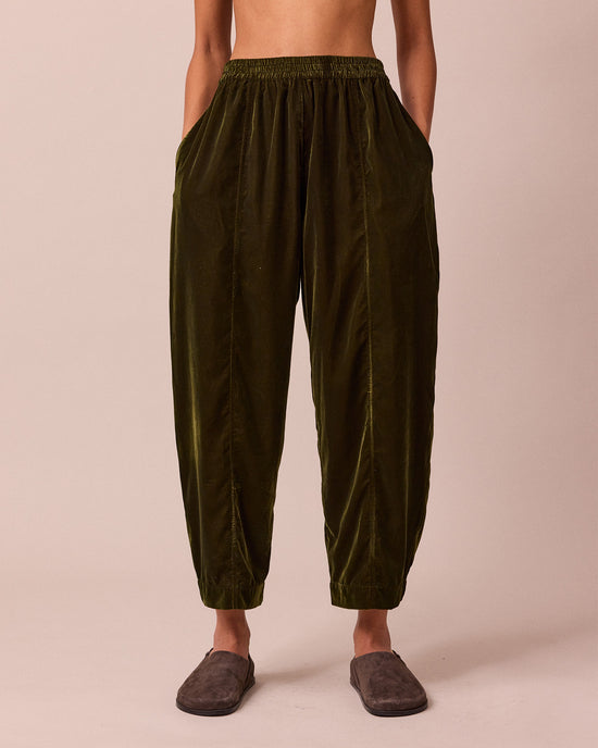 model wears mabel moss green velvet trousers front