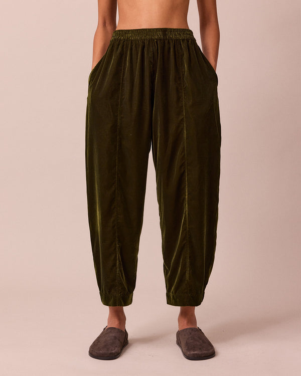 model wears mabel moss green velvet trousers front
