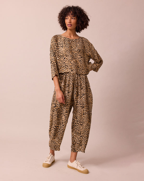 model wears mabel leopard print cupro trousers right