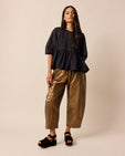 model wears mabel bronze linen trousers right