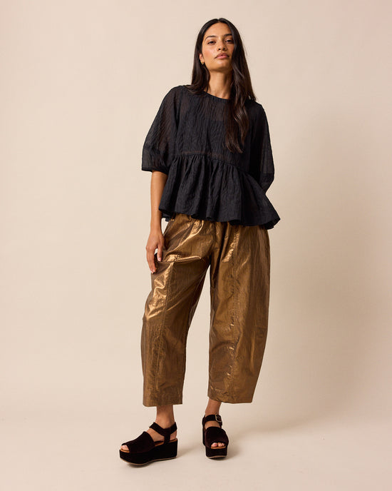 model wears mabel bronze linen trousers right