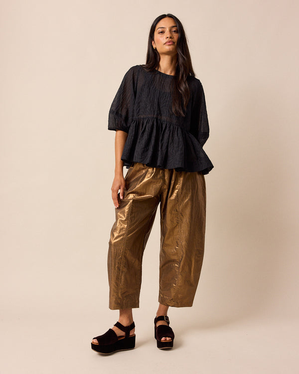 model wears mabel bronze linen trousers right
