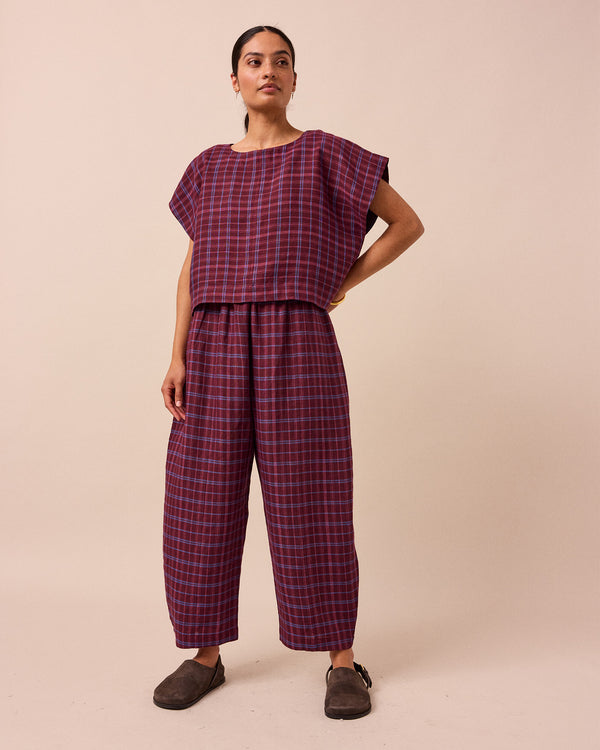 model wears mabel mulberry check linen trousers front