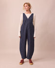 model wears ottie navy pinstripe denim jumpsuit