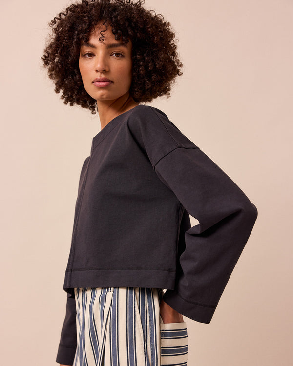 model wears peggy washed black jersey top