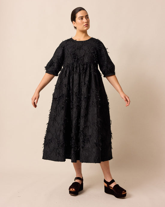 model wears prue black tufted dress