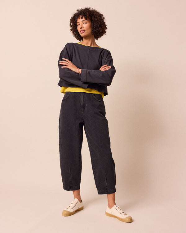 model wears remi washed black jeans front