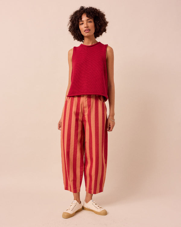 model wears peach and russet remi denim trousers front