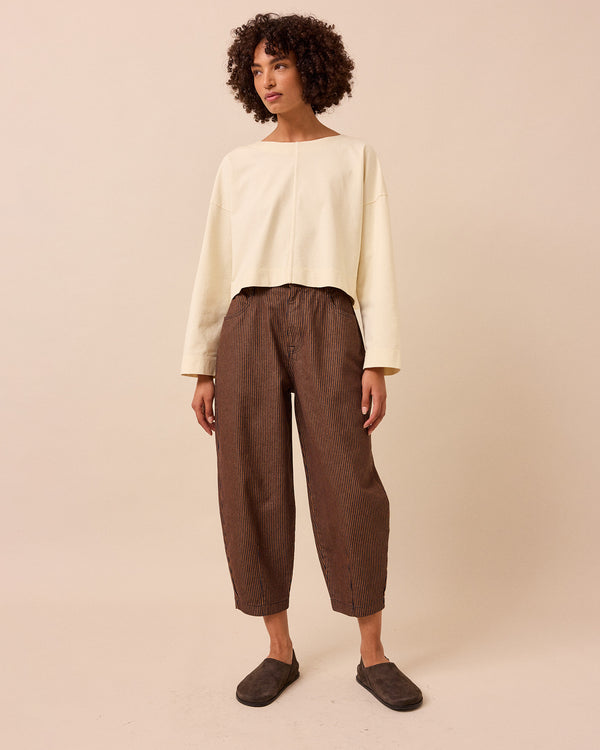 model wears remi hickory rust stripe jeans front