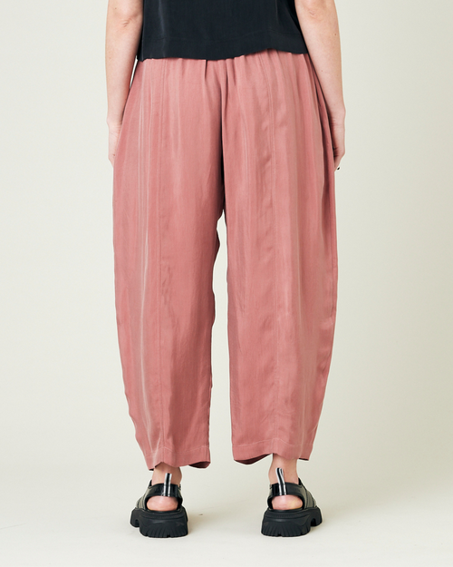 model wears dusty pink cupro mabel trousers back