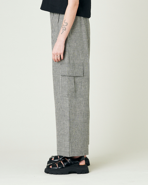 model wears black and stone micro gingham orla trousers left