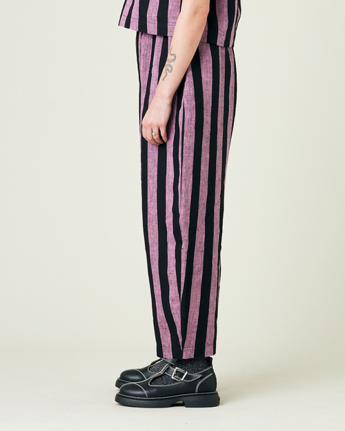 model wears pink and black stripe linen mabel trousers from the left