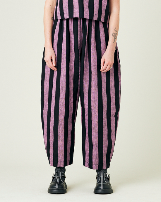 model wears pink and black stripe linen mabel trousers from the front