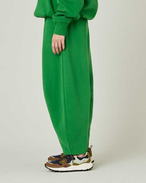 model wears juniper green daisy jersey trousers left