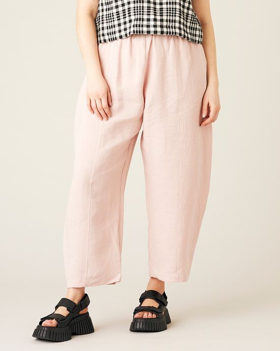 model wears rose linen mabel trousers from the front